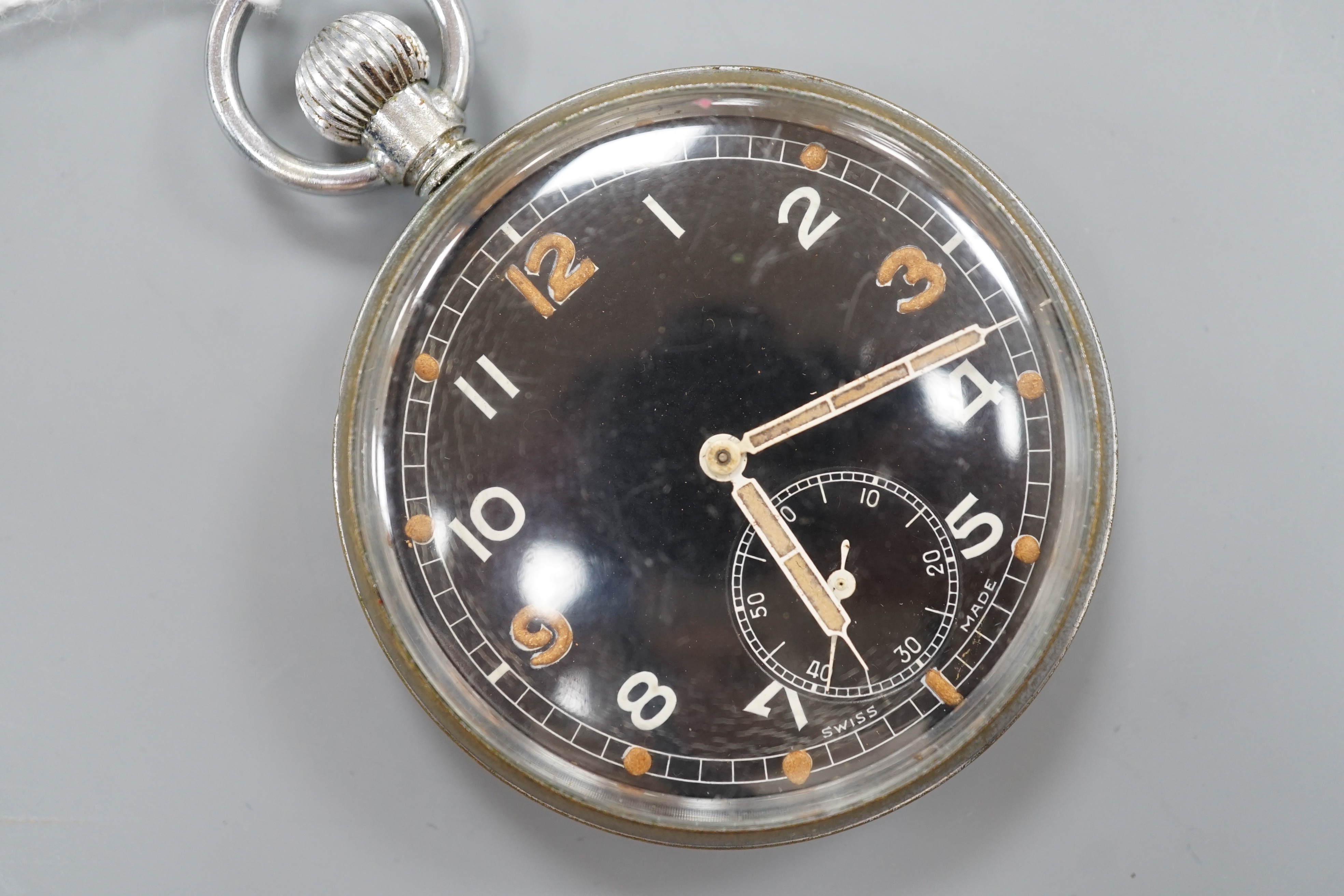 A military issue chrome cased keyless pocket watch, with black Arabic dial and subsidiary seconds, the case back engraved with broad arrow G.S.T.P. over Q 8315.